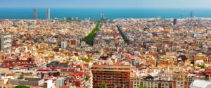 vista panoramica de Barcelona con edificios en primer plano y el mar de fondo